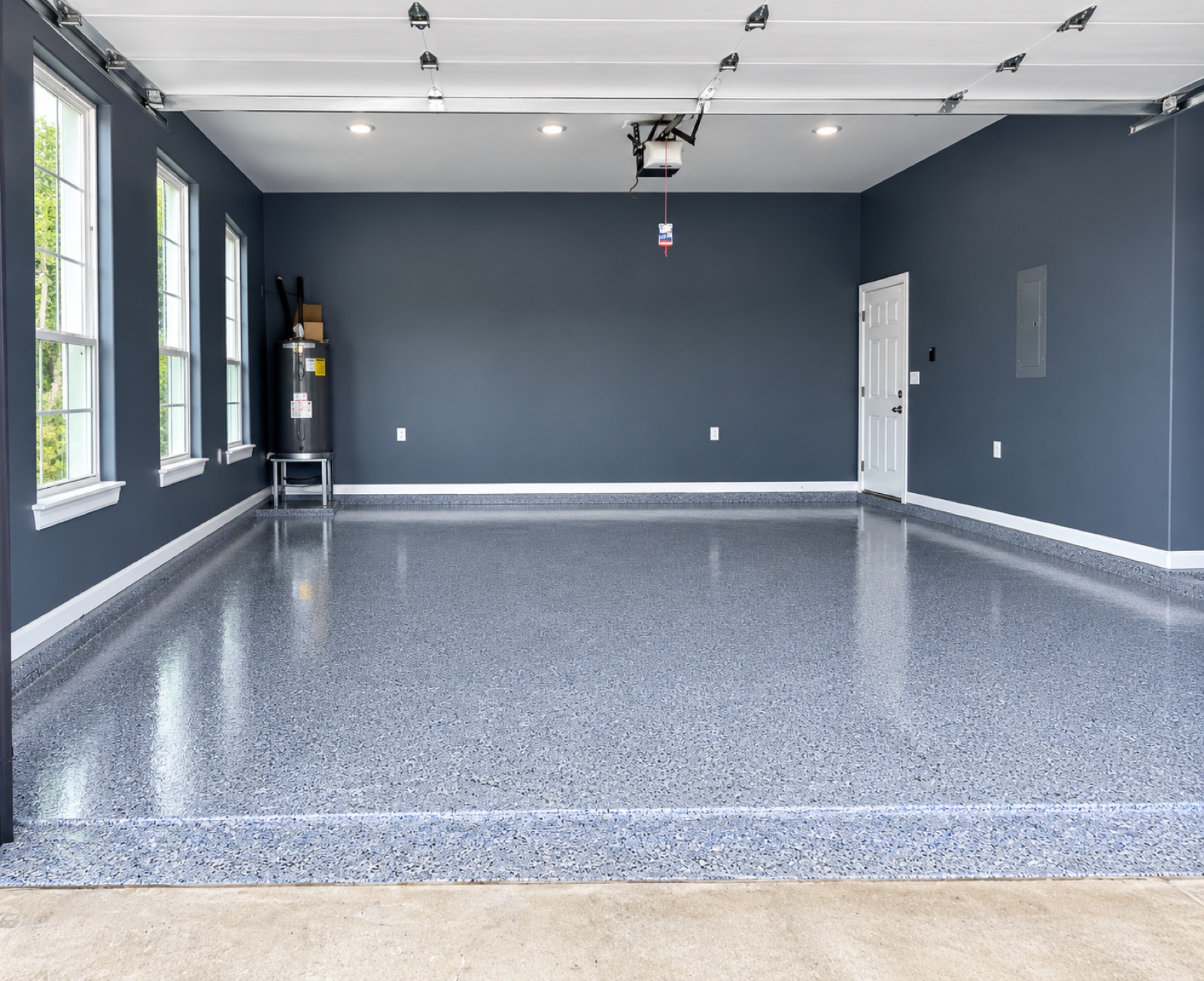 Interior painting — garage with navy walls and a professional epoxy floor coating
